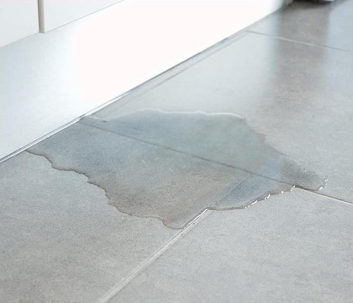 puddle of water on tile floor
